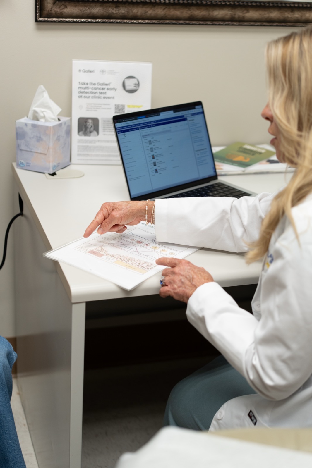 Dr. Myra Reed reviewing patient health information at her desk