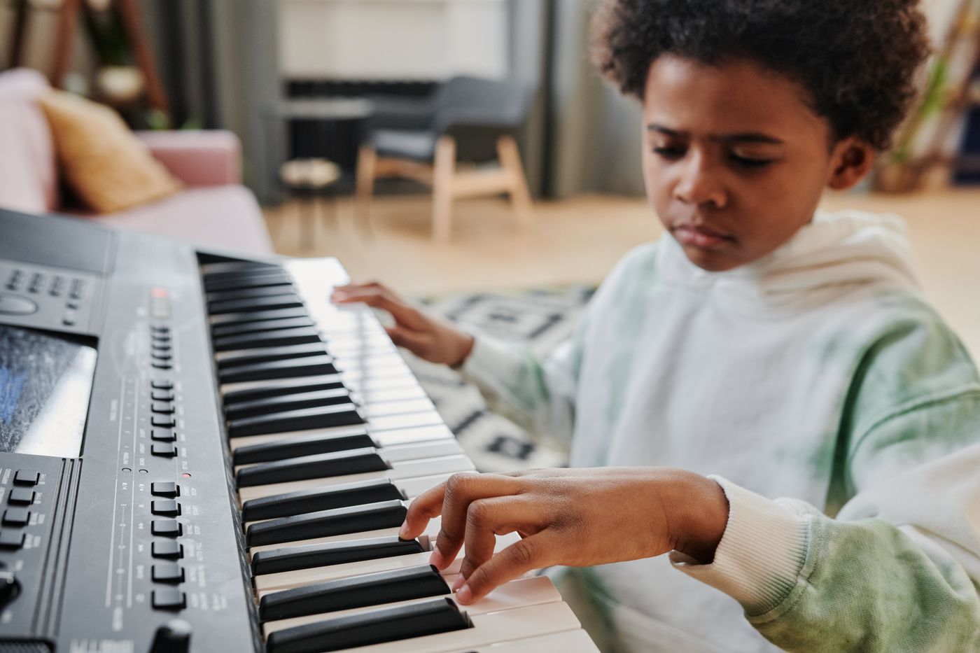 A child learning to play piano at home