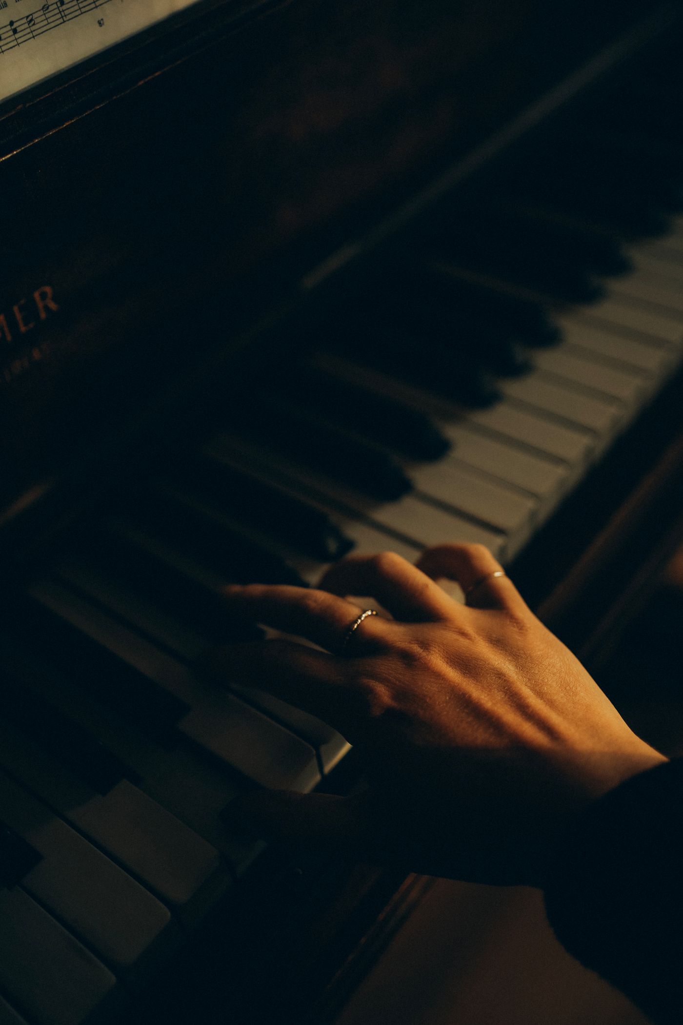 Close-up of hands on classic piano keys